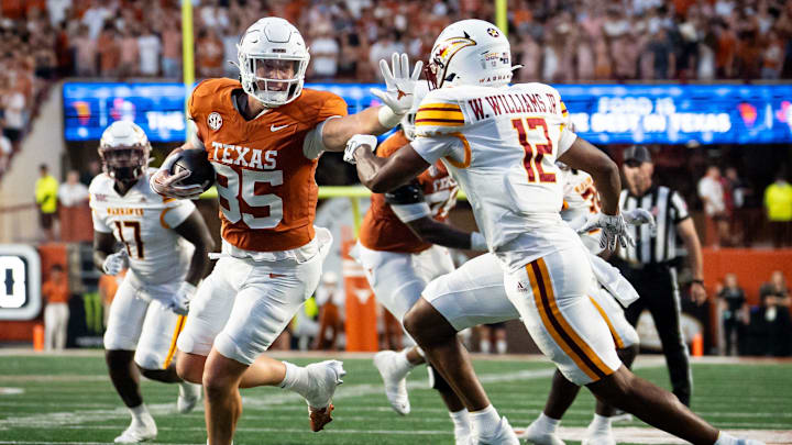 Texas Longhorns tight end Gunnar Helm (85) sticks out an arm to protect the ball as Louisiana Monroe Warhawks defensive back Wydett Williams Jr. (12) goes for the tackle in the first half of the Texas Longhorns' game against the ULM Warhawks at Darrell K Royal Texas Memorial Stadium in Austin, Sept. 21, 2024. Texas Longhorns tight end Gunnar Helm (85) sticks out an arm to protect the ball as Louisiana Monroe Warhawks defensive back Wydett Williams Jr. (12) goes for the tackle in the first half of the Texas Longhorns' game against the ULM Warhawks at Darrell K Royal Texas Memorial Stadium in Austin, Sept. 21, 2024.