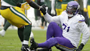 Nov 23, 2025; Green Bay, Wisconsin, USA; Green Bay Packers defensive end Micah Parsons (1) helps Minnesota Vikings offensive tackle Christian Darrisaw (71) off the ground at Lambeau Field.
