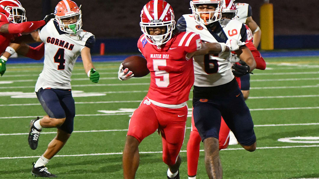 Mater Dei defensive back CJ Lavender Jr. attempts to elude a Bishop Gorman player after making an interception.