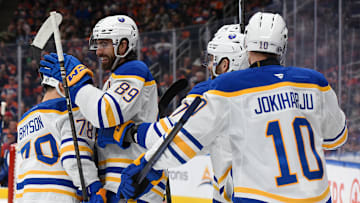 Alex Tuch (89), Jacob Bryson (78), and Henri Jokiharju (10) celebrating a goal against the Edmonton Oilers. 
