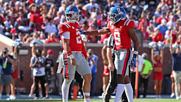 Jaxson Dart #2 and Tre Harris #9 of the Mississippi Rebels celebrate during the game against the Middle Tennessee Blue Raiders at Vaught-Hemingway Stadium on September 07, 2024 in Oxford, Mississippi.