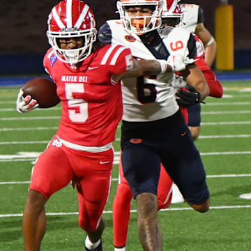 Mater Dei defensive back CJ Lavender Jr. attempts to elude a Bishop Gorman player after making an interception.