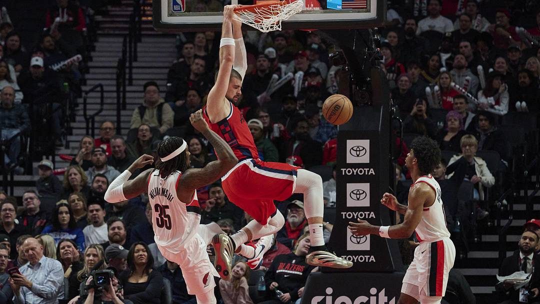 Jan 16, 2025; Portland, Oregon, USA; LA Clippers center Ivica Zubac (40) dunks the basketball during the second half against Portland Trail Blazers center Robert Williams III (35) and guard Scoot Henderson (00) at Moda Center. Mandatory Credit: Troy Wayrynen-Imagn Images