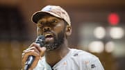 Randy Moss speaks during a charity basketball game.