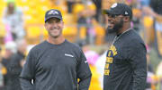 Oct 6, 2019; Pittsburgh, PA, USA; Baltimore Ravens head coach John Harbaugh (left) talks with Pittsburgh Steelers head coach Mike Tomlin before a game at Heinz Field. Mandatory Credit: Philip G. Pavely-Imagn Images