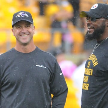 Oct 6, 2019; Pittsburgh, PA, USA; Baltimore Ravens head coach John Harbaugh (left) talks with Pittsburgh Steelers head coach Mike Tomlin before a game at Heinz Field. Mandatory Credit: Philip G. Pavely-Imagn Images