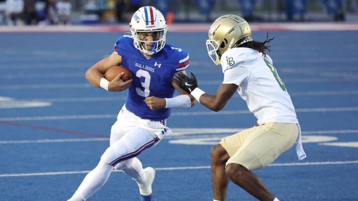 Folsom (California) quarterback Ryder Lyons prepares to take on a Long Beach Poly defender.