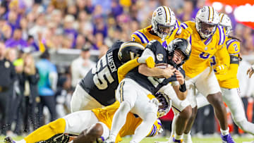 Diego Pavia 2 is sacked by Defensive end Sai'vion Jones 35 as the Tigers LSU Tigers take on the Vanderbilt Commodores. Nov 23, 2024; Baton Rouge, Louisiana, USA; at Tiger Stadium.