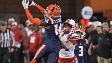 Oct 6, 2023; Champaign, Illinois, USA; Illinois Fighting Illini defensive back Xavier Scott (14) intercepts the ball in front of intended Nebraska Cornhuskers wide receiver Alex Bullock (84) during the second half at Memorial Stadium. Mandatory Credit: Ron Johnson-USA TODAY Sports