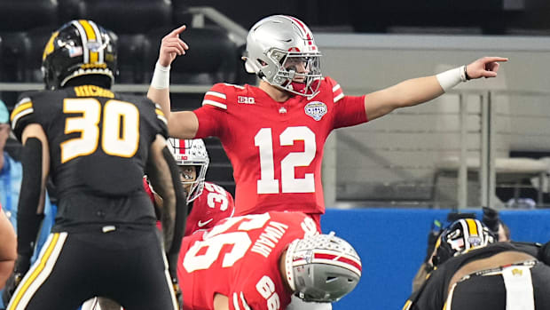 Dec 29, 2023; Arlington, Texas, USA; Ohio State Buckeyes quarterback Lincoln Kienholz (12) motions at the line of scrimmage d
