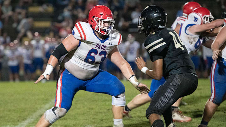 Grant Wise (63) gets set to engage with Saleem Mickles (44) during the Pace vs Milton football game