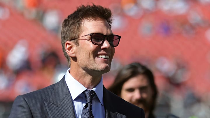 Brady smiles before an NFL football game at Huntington Bank Field.