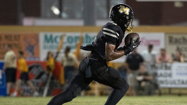 Milton's Kaiden Hall No. 3) pulls in the pass for a huge gain against the Gulf Breeze defense during Friday night's gridiron action.