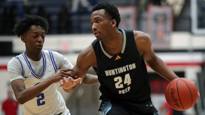 Huntington Prep gaurd Darryn Peterson, right, drives to the basket against Richmond Heights guard Demaris Winters Jr. during the first half of a basketball game in the Canton Play-By-Play Classic at Canton Memorial Field House, Saturday, Feb. 17, 2024, in Canton, Ohio.