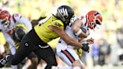 Oct 26, 2024; Eugene, Oregon, USA; Oregon Ducks defensive end Matayo Uiagalelei (10) tackles Illinois Fighting Illini quarterback Luke Altmyer (9) during the second half at Autzen Stadium. Mandatory Credit: Troy Wayrynen-Imagn Images