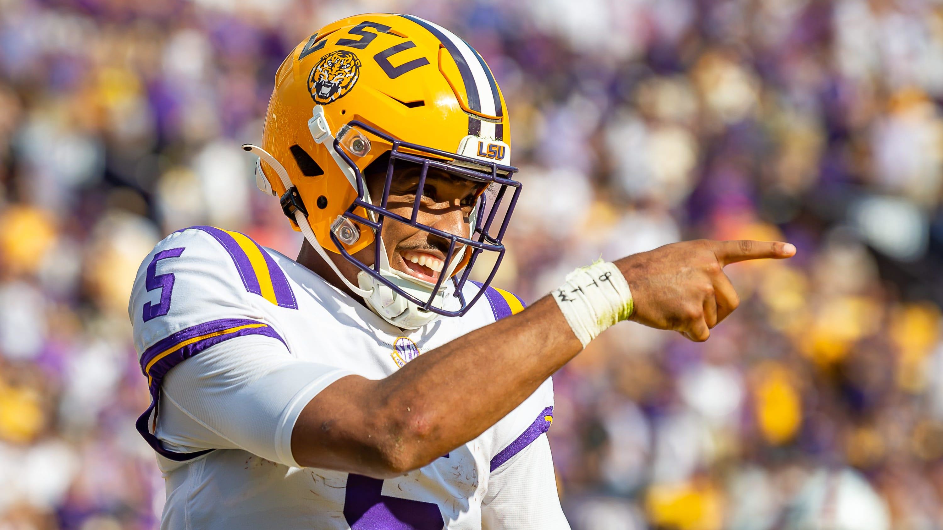 Quarterback Jayden Daniels celebrates after scoring a touchdown as the LSU Tigers take on Ole Miss.