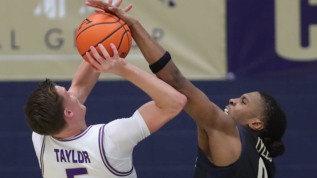 Akron Zips forward Amani Lyles (0) blocks a shot by James Madison Dukes forward Justin Taylor (5) on Nov. 3, 2025, in Akron. Akron Zips forward Amani Lyles (0) blocks a shot by James Madison Dukes forward Justin Taylor (5) on Nov. 3, 2025, in Akron.