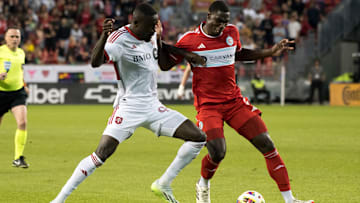 Prince Owusu #99 (L) and Carlos Terán #4 (R) seen in action...