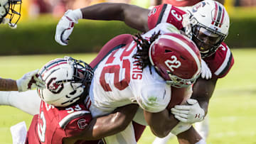 Sep 14, 2019; Columbia, SC, USA; South Carolina Gamecocks linebacker Ernest Jones (53) and defensive lineman Javon Kinlaw (3) tackle Alabama Crimson Tide running back Najee Harris (22) at Williams-Brice Stadium. Mandatory Credit: Jeff Blake-Imagn Images