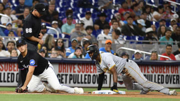 Pittsburgh Pirates center fielder Michael A. Taylor slides into thrid base ahead of the tag by Miami Marlins infielder Jonah Bride