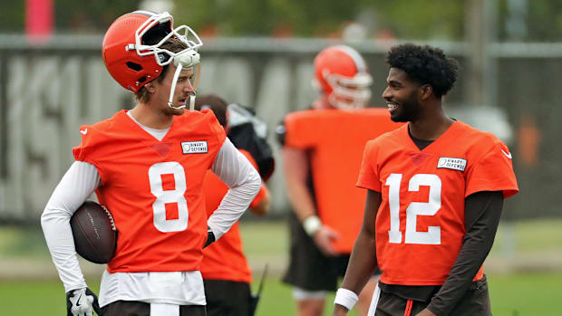 Cleveland Browns quarterback Kenny Pickett, left, chats with quarterback Shedeur Sanders (12) during an NFL practice at the C