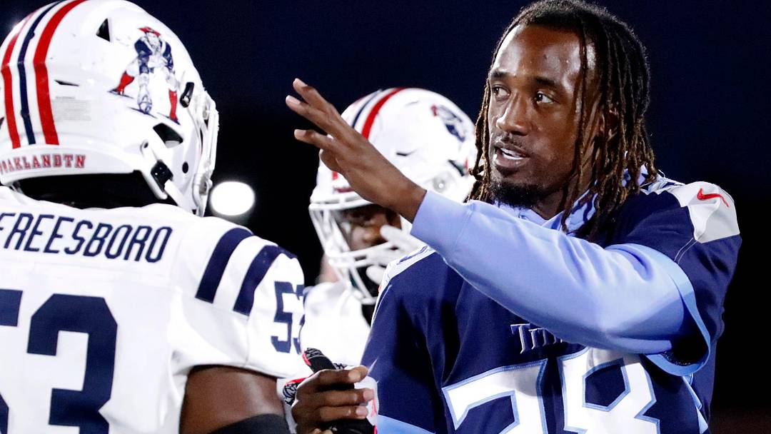 Tennessee Titan's player L'Jarius Sneed greets Oakland's Khameron Sanders (53) and other Oakland and Blackman players after the coin toss before the start of the football game between Blackman and Oakland at Blackman on Friday, Sept 26, 2025.