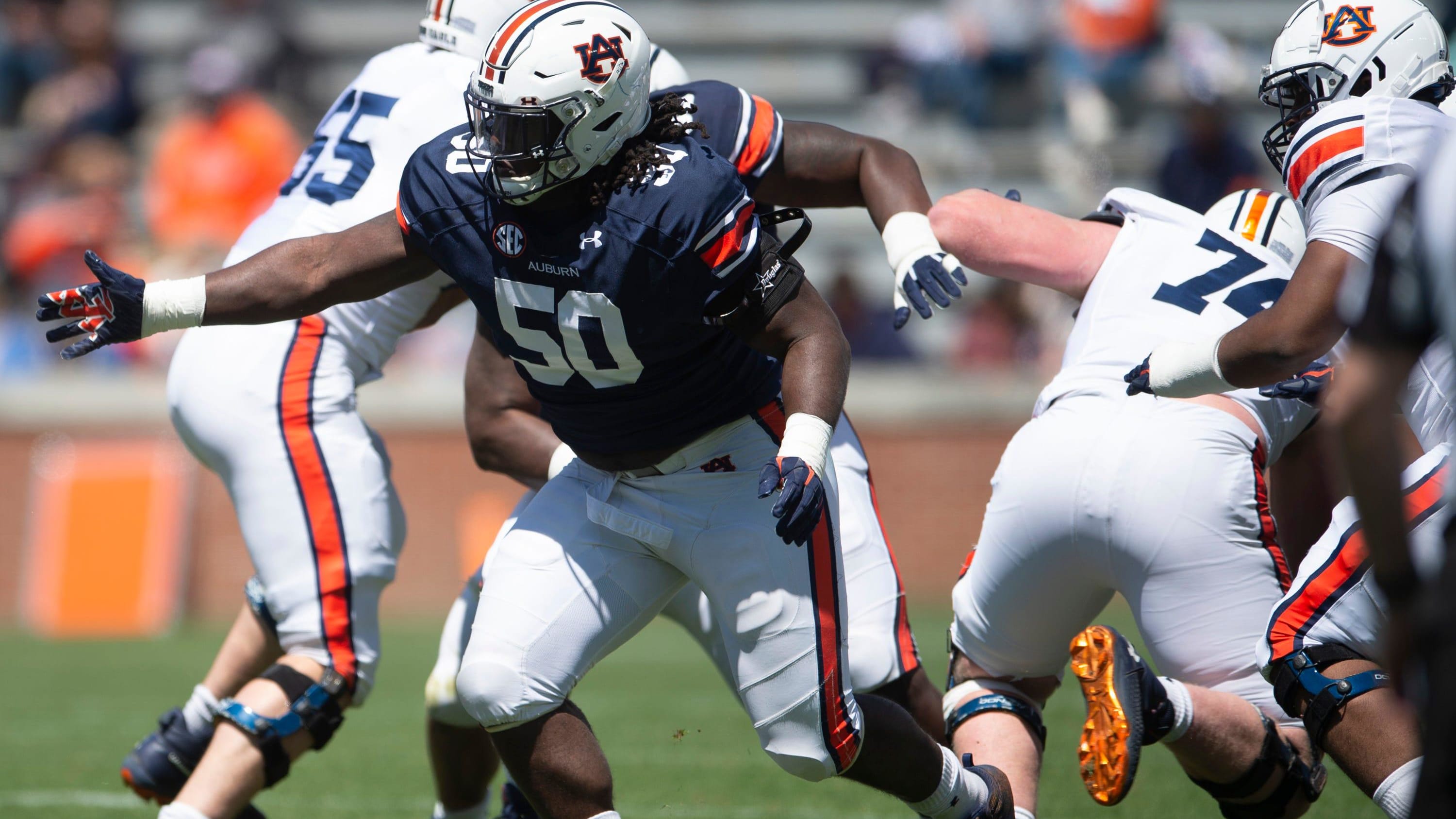 Auburn Tigers defensive lineman Marcus Harris (50) breaks through the line during the A-Day spring game.