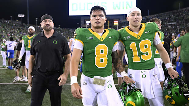 Oregon Ducks quarterback Dillon Gabriel (8) and quarterback Ryder Hayes (19) walk off the field 