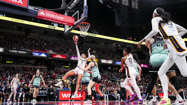 Indiana Fever guard Sophie Cunningham (8) goes up for a basket against New York Liberty guard Marine Johannès (23)