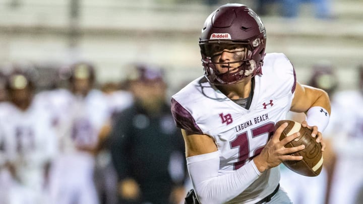 Laguna Beach's Jackson Kollock (12) looks to pass during the second quarter of their CIF-SS quarterfinal game in La Quinta, Calif., Friday, Nov. 11, 2022.