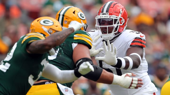 Cleveland Browns defensive tackle Mike Hall Jr. (51) works around a pair of Green Bay Packers players during the first half of an NFL preseason football game at Cleveland Browns Stadium, Saturday, Aug. 10, 2024, in Cleveland, Ohio.