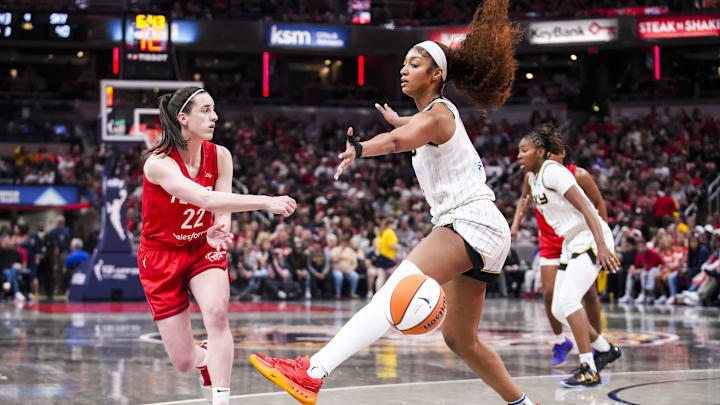 Indiana Fever guard Caitlin Clark passes around Chicago Sky forward Angel Reese. Indiana Fever guard Caitlin Clark passes around Chicago Sky forward Angel Reese.