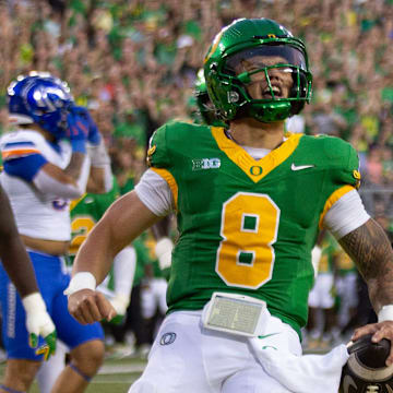 Oregon quarterback Dillon Gabriel, right, celebrates a first quarter touchdown against Boise State at Autzen Stadium in Eugene Sept. 7, 2024.