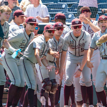 Jun 21, 2022; Omaha, NE, USA; Texas A&M Aggies third baseman Trevor Werner (28) celebrates with teammates after scoring on a home run against the Notre Dame Fighting Irish during the fifth inning at Charles Schwab Field.