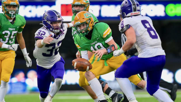 Brock Beaner, left, and Tyler Olson close in on a tackle during Anacortes' 60-30 win over Tumwater to win WIAA Class 2A title