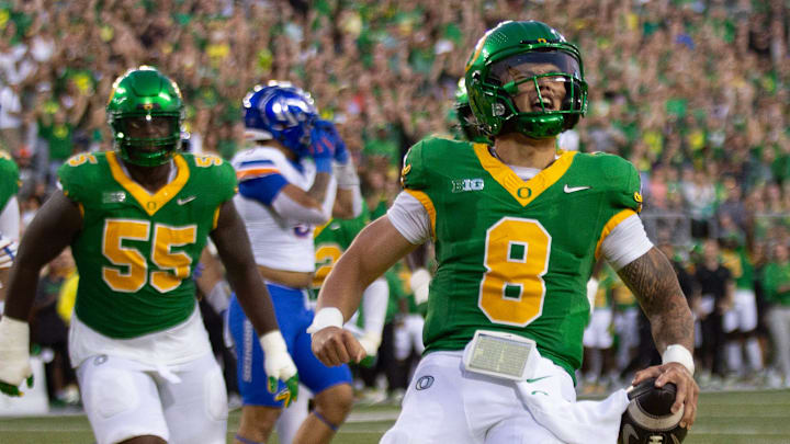 Oregon quarterback Dillon Gabriel, right, celebrates a first quarter touchdown against Boise State at Autzen Stadium in Eugene Sept. 7, 2024.