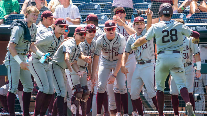 Jun 21, 2022; Omaha, NE, USA; Texas A&M Aggies third baseman Trevor Werner (28) celebrates with teammates after scoring on a home run against the Notre Dame Fighting Irish during the fifth inning at Charles Schwab Field.