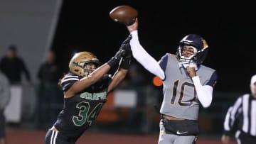 Warren quarterback Madden Iamaleava is under pressure by St. Bonaventure's Jacob Moraga as he fires a pass during the first quarter of the Seraphs' 24-21 win in the CIF-SS Division 3 championship game on Saturday, Nov. 25, 2023, at Ventura High's Larrabee Stadium.