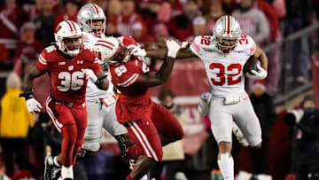 Oct 28, 2023; Madison, Wisconsin, USA; Ohio State Buckeyes running back TreVeyon Henderson (32) runs through Wisconsin Badgers linebacker Maema Njongmeta (55) during the second half of the NCAA football game at Camp Randall Stadium. Ohio State won 24-10.