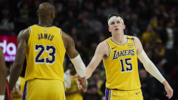 Los Angeles Lakers guard Austin Reaves (15) high-fives forward LeBron James (23) during the second half against the Portland Trail Blazers at Moda Center.