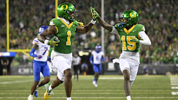 Sep 7, 2024; Eugene, Oregon, USA; Oregon Ducks wide receiver Traeshon Holden (1) high-fives wide receiver Tez Johnson (15) as he scores a touchdown during the second half against the Boise State Broncos at Autzen Stadium. Mandatory Credit: Troy Wayrynen-Imagn Images