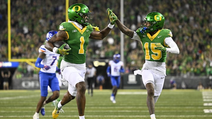 Sep 7, 2024; Eugene, Oregon, USA; Oregon Ducks wide receiver Traeshon Holden (1) high-fives wide receiver Tez Johnson (15) as he scores a touchdown during the second half against the Boise State Broncos at Autzen Stadium. Mandatory Credit: Troy Wayrynen-Imagn Images