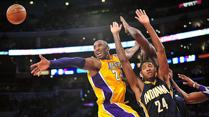 November 27, 2012; Los Angeles, CA, USA; Los Angeles Lakers shooting guard Kobe Bryant (24) turns the ball over against the defense of Indiana Pacers small forward Paul George (24) during the first half at Staples Center. Mandatory Credit: Gary A. Vasquez-Imagn Images