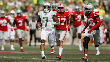 Oregon Ducks running back CJ Verdell (7) runs past Ohio State Buckeyes safety Bryson Shaw (17) and cornerback Cameron Brown (26) for a 77-yard touchdown during the third quarter of the NCAA football game at Ohio Stadium in Columbus on Saturday, Sept. 11, 2021.