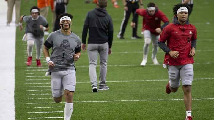 Jan 1, 2021; New Orleans, LA, USA;  Ohio State Buckeyes quarterback Justin Fields (1) and quarterback C.J. Stroud (14) warm up prior to the College Football Playoff semifinal against the Clemson Tigers at the Allstate Sugar Bowl in the Mercedes-Benz Superdome in New Orleans on Friday, Jan. 1, 2021. Mandatory Credit: Adam Cairns-USA TODAY Sports