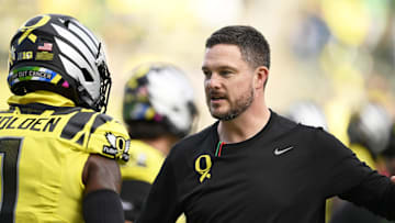 Oct 26, 2024; Eugene, Oregon, USA; Oregon Ducks head coach Dan Lanning visits with players before a game against the Illinois Fighting Illini at Autzen Stadium. Mandatory Credit: Troy Wayrynen-Imagn Images