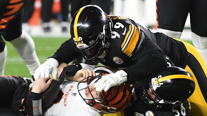 Dec 23, 2023; Pittsburgh, Pennsylvania, USA; Cincinnati Bengals quarterback Jake Browning (6) is sacked by Pittsburgh Steelers linebacker Alex Highsmith (56) as defensive tackle Larry Ogunjobi (99) takes part on the third quarter play. Dec 23, 2023; Pittsburgh, Pennsylvania, USA; Cincinnati Bengals quarterback Jake Browning (6) is sacked by Pittsburgh Steelers linebacker Alex Highsmith (56) as defensive tackle Larry Ogunjobi (99) takes part on the third quarter play.