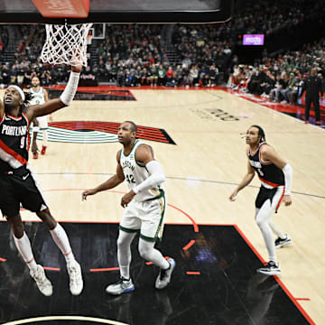 Mar 11, 2024; Portland, Oregon, USA; Boston Celtics guard Jaylen Brown (7) scores a basket during the first half against Portland Trail Blazers forward Jerami Grant (9) at Moda Center. Mandatory Credit: Troy Wayrynen-Imagn Images