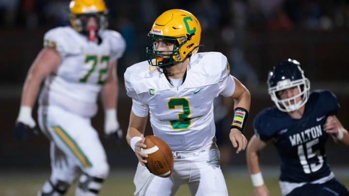 Quarterback Ryan Huff (3) looks for an open receiver during the Catholic vs Walton high school playoff football game at Walton HIgh School in DeFuniak Springs on Friday, Nov. 17, 2023.