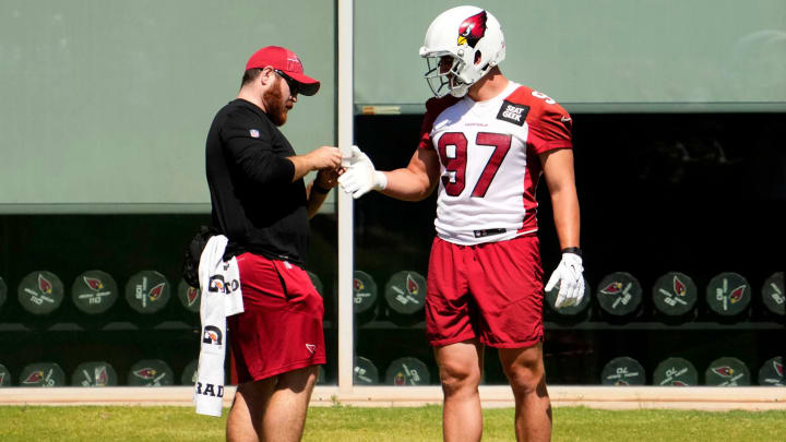 Arizona Cardinals outside linebacker Cameron Thomas (97) gets his hand taped during minicamp at the Cardinals Dignity Health Training Center in Tempe on June 13, 2023.